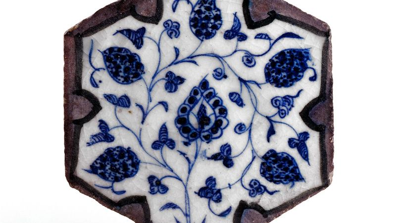 : A blue and white tile with a floral pattern from 15th-century Syria.