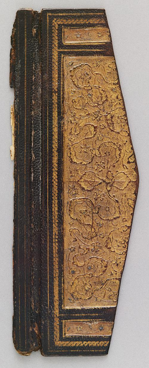 Flap of a black leather bookbinding, with gold panel gilt-stamped Chinese cloud motifs.