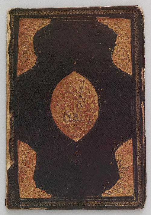 Chestnut-coloured leather bookbinding and decorated with a central oval medallion filled with a two-tier design of scrolling branches and flowers overlaid by a cloud motif. The cornerpieces are filled with a design of branches and leaves.