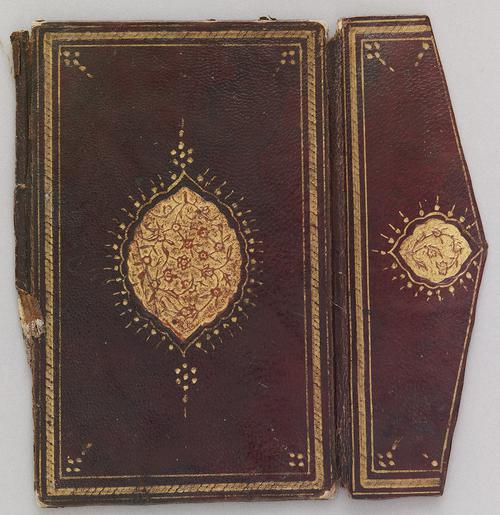 The light chestnut-coloured leather outer cover and flap decorated with a recessed lobed medallion and rosettes formed by dots. The medallions are filled with stamped and gilded designs of flowers on curved branches.