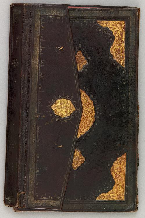 Front of black leather eighteenth-century Turkish book binding with flap folded over. Gilt embossed centre motif, and further decorated with gilt embossed corners on the front cover. Flap also has a delicate gilt embossed motif.