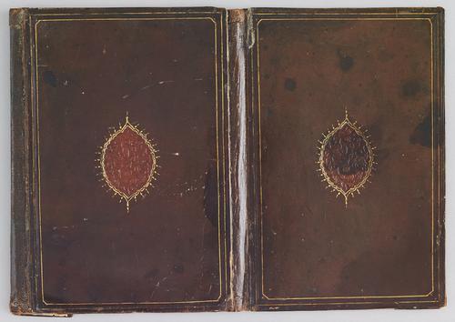 Chestnut-coloured leather binding with flap laid out flat. Covers decorated with a recessed oval medallion. On the flap a small recessed circular medallion. All medallions are decorated with a stamped design of flowers on curving branches. 