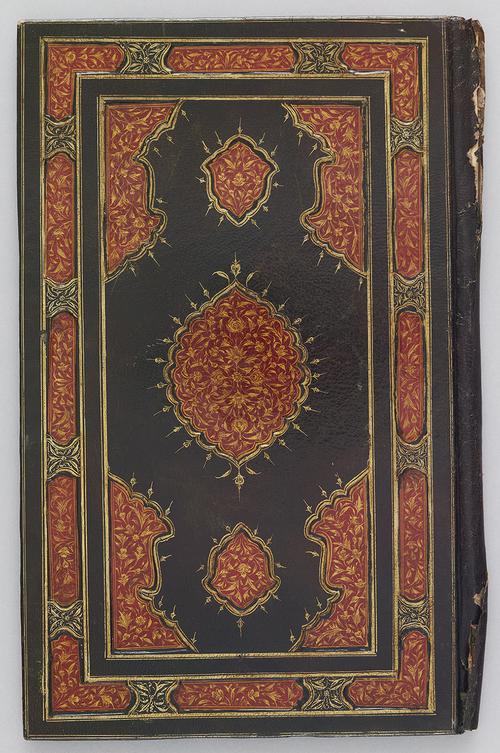 Back of dark green leather bookbinding. Red and gold gilt-stamped border, with intricate floral patterns. Centre medallion is also red, and gold gilt-stamped with similar floral patterns as the border 