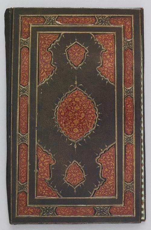 Front of dark green leather bookbinding. Red and gold gilt-stamped border, with intricate floral patterns. Centre medallion is also red, and gold gilt-stamped with similar floral patterns as the border 