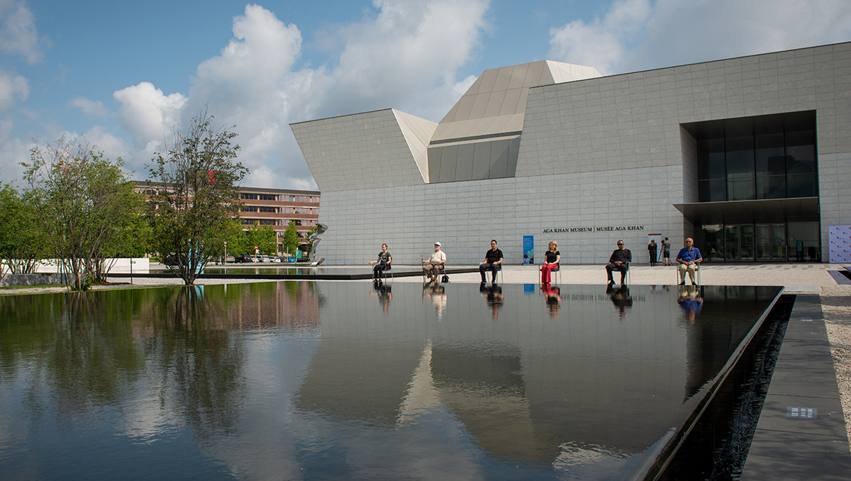 People meditate while sitting in chairs in front of the west entrance of Toronto's Aga Khan Museum.
