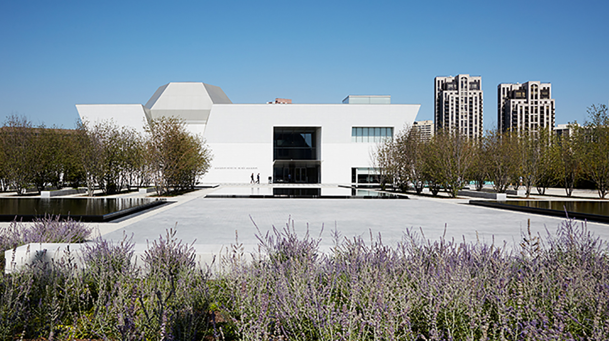 The Aga Khan Museum on a sunny summer day with lavender flowers in the foreground.