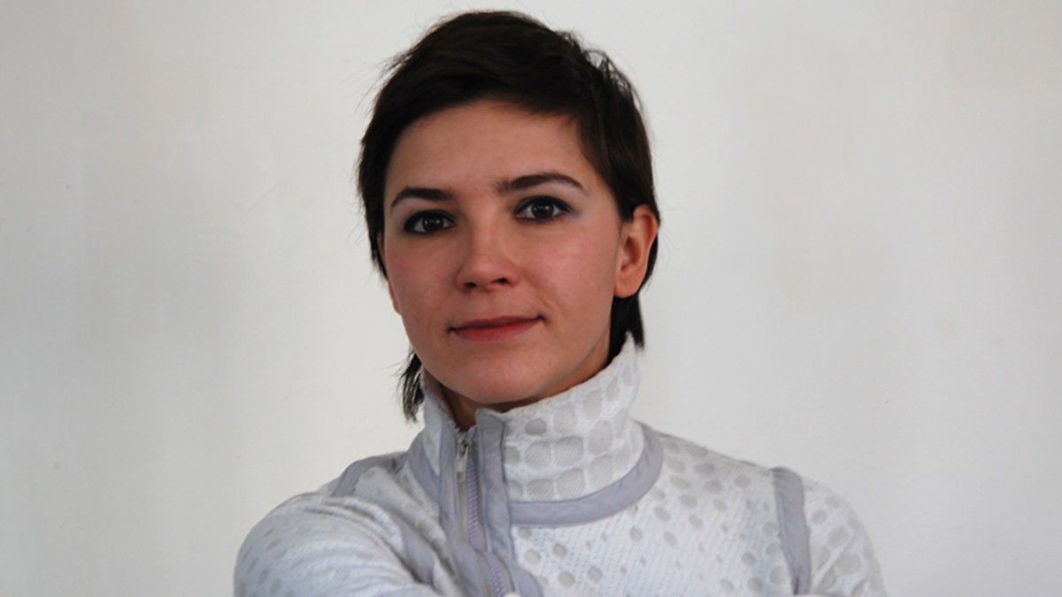Dr. Azra Akšamija, wearing a white zippered turtleneck.