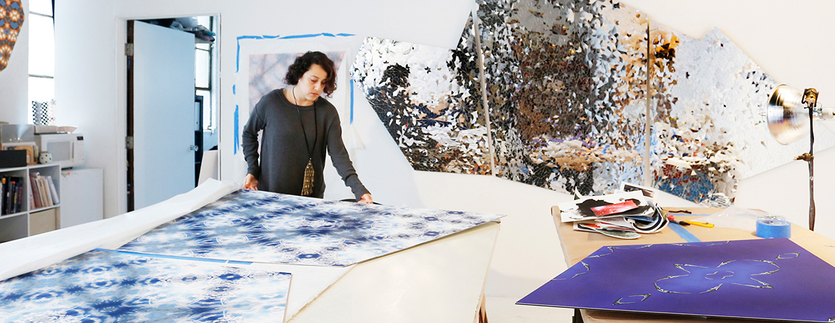 Sanaz Mazinani arranges an artwork on the table of her studio. 