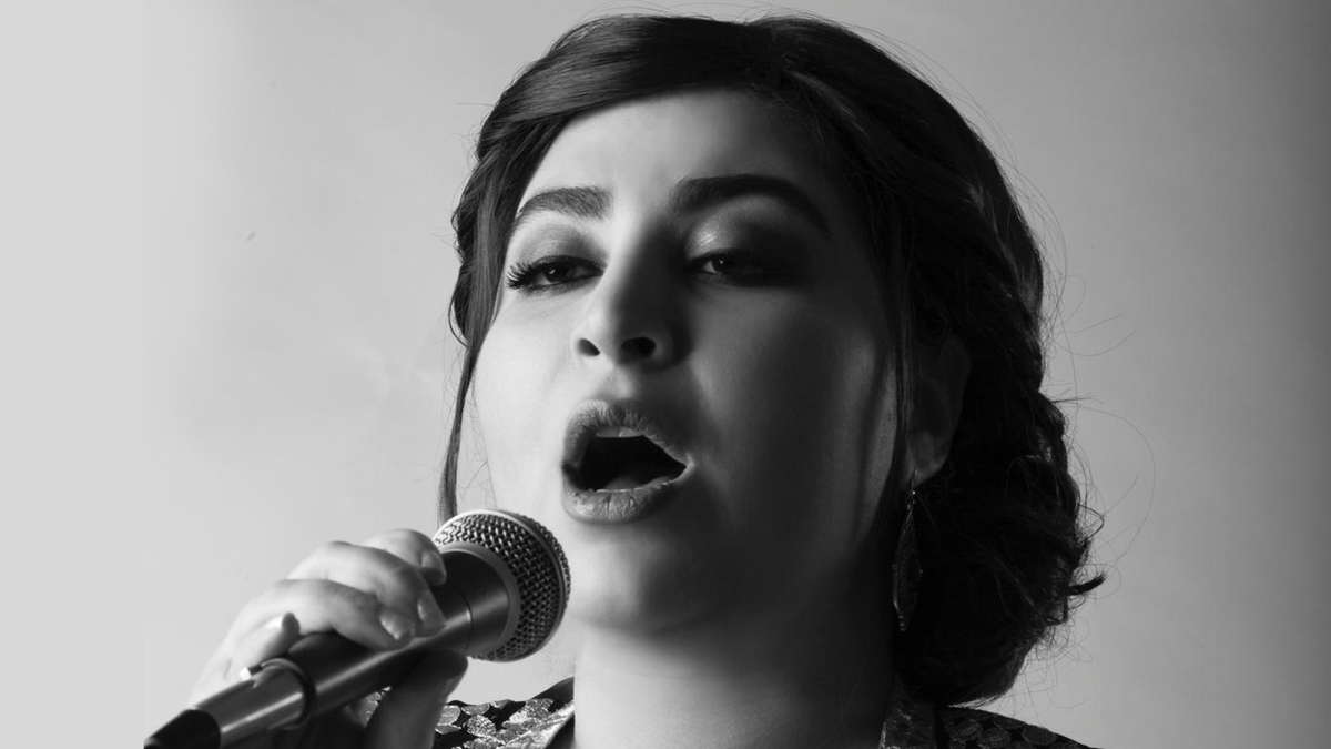 Sara Hamidi sings with her eyes closed in this portrait
