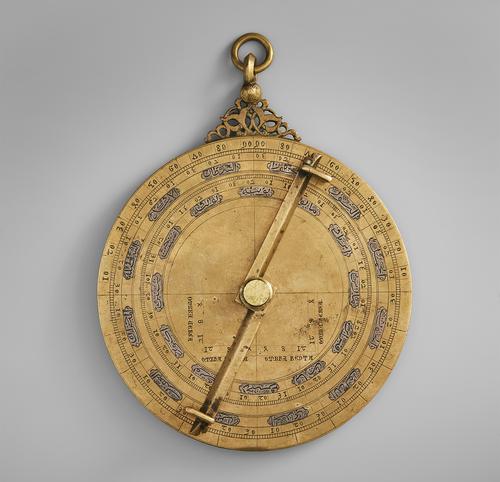 Back of the astrolabe, showing the pin that holds the plates together and the back of the last plate featuring scientific markings.