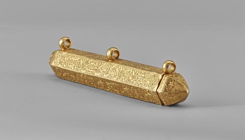 Gold amulet in the shape of a hexagonal prism with pointed ends, has three suspension loops from which it would have been attached to a chain or cord and worn around the neck or secured to a belt. It is inscribed with Qur’anic verses.