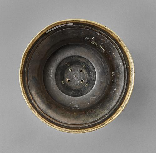 Round bottom of a candlestick with truncated engraved body.
