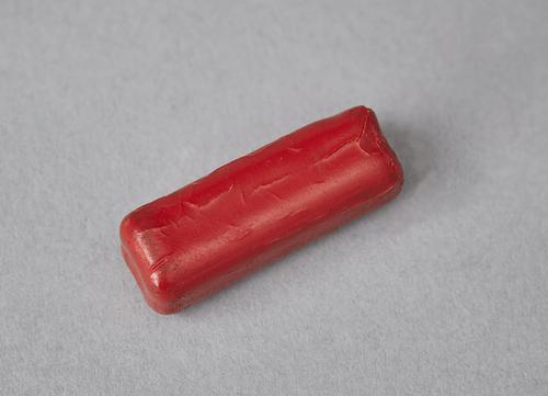 Red piece of wax.