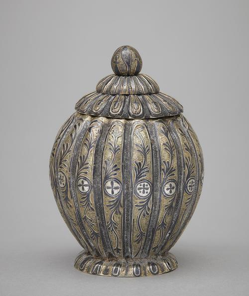 Lobed silver and gilded pot with floral design, with lid taken off.