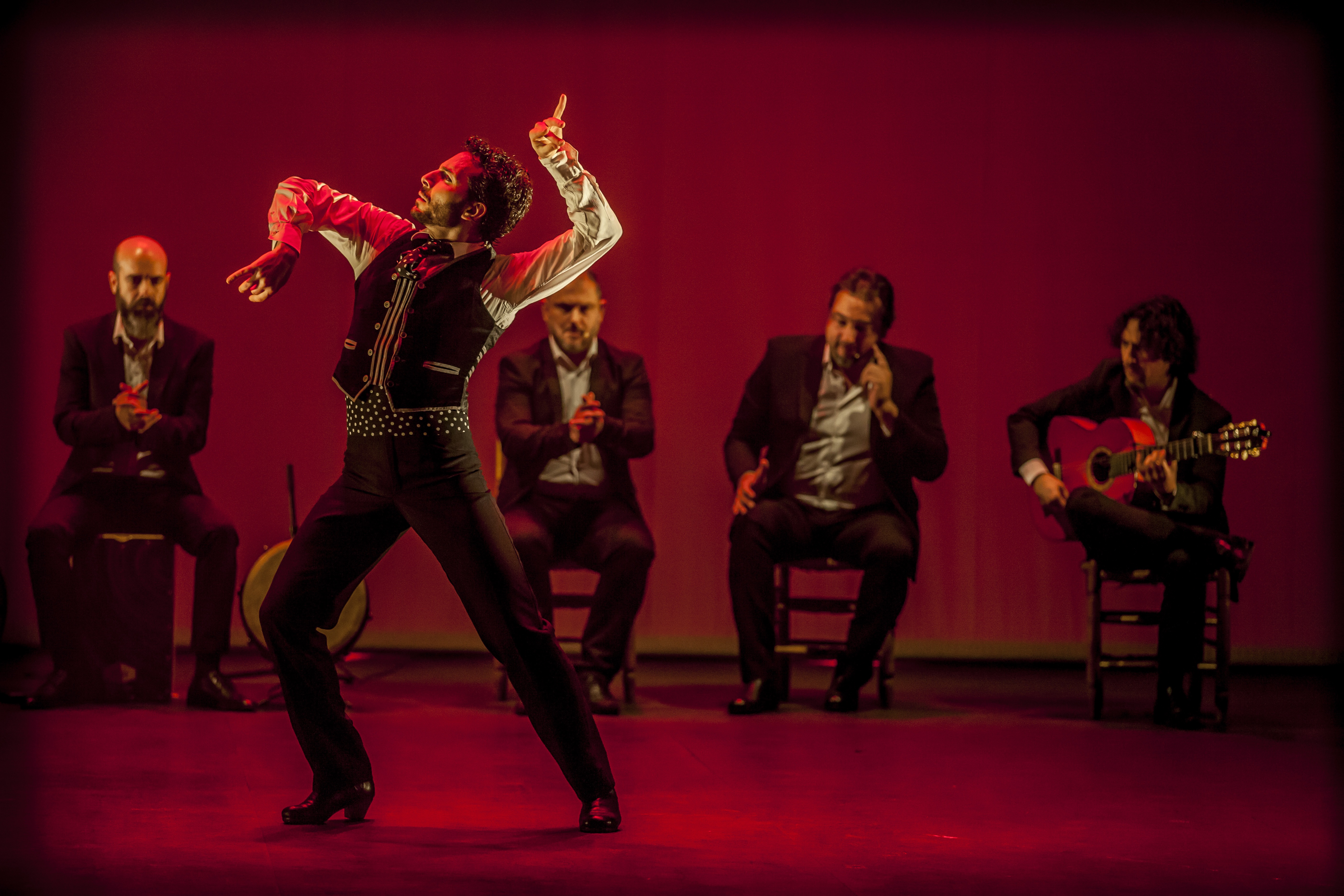 Flamenco dancer on stage with musicians